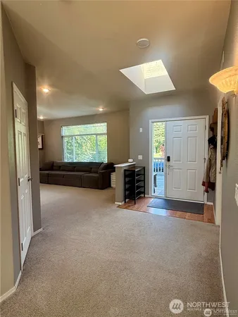 a living room with furniture and a floor to ceiling window