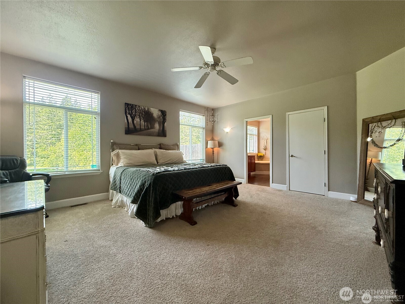 168 Jackson Road Orcas Island, WA 98245 - Photo 27 of 40 a bedroom with a bed a couch and a flat tv screen on dresser