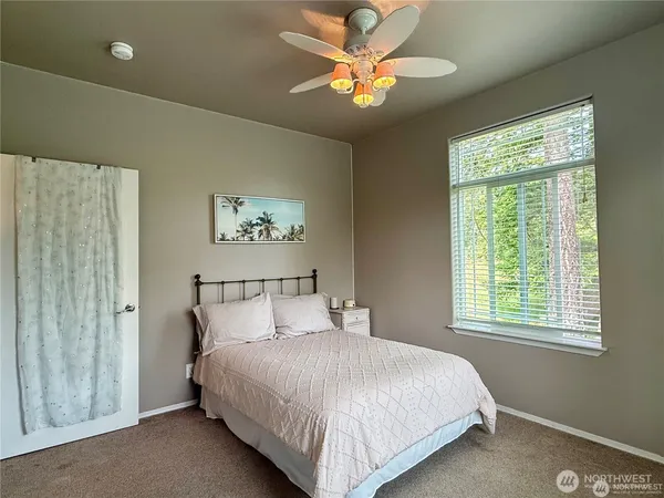 a bed room with a bed and a window