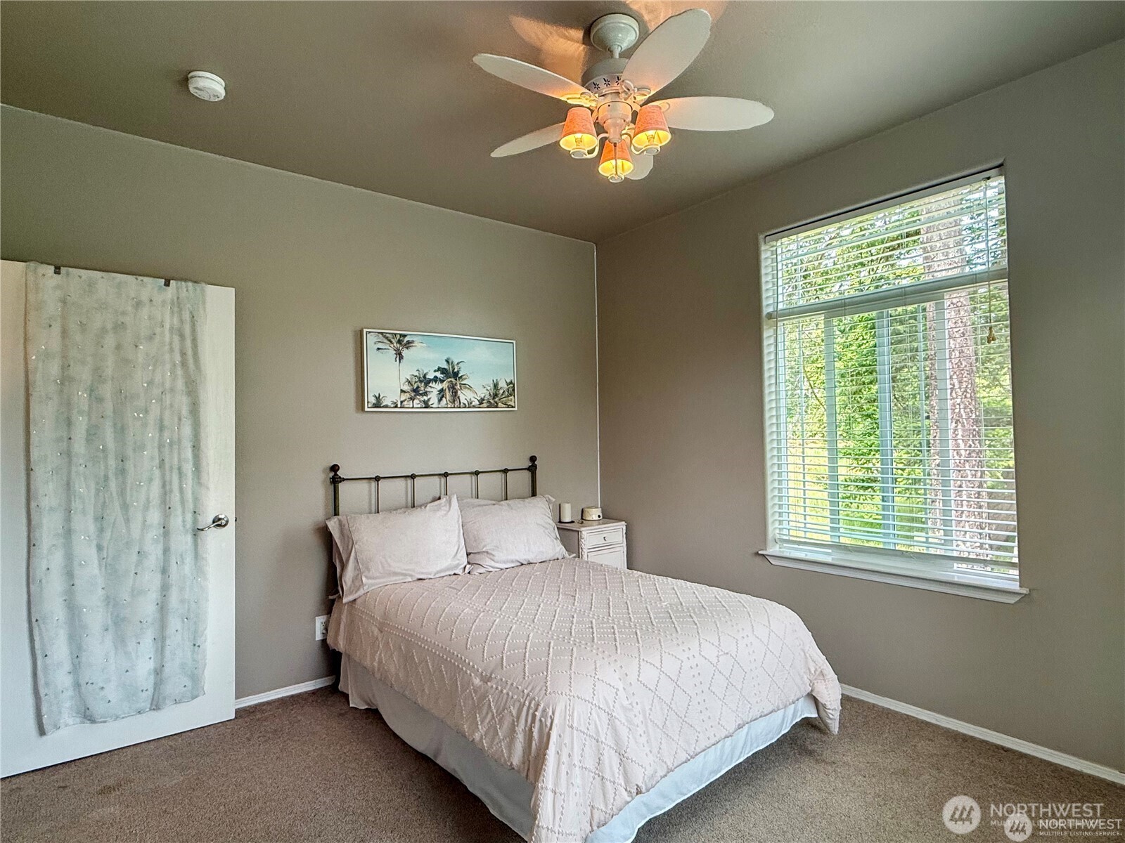 168 Jackson Road Orcas Island, WA 98245 - Photo 32 of 40 a bedroom with a bed and a chandelier