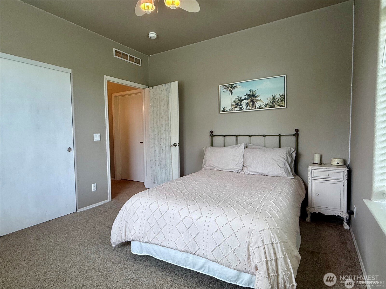 168 Jackson Road Orcas Island, WA 98245 - Photo 33 of 40 a bedroom with a large bed and a chandelier
