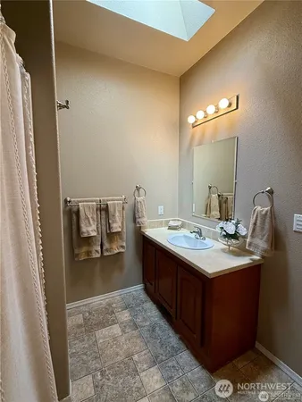 a bed sitting in a bedroom next to a window with cabinet