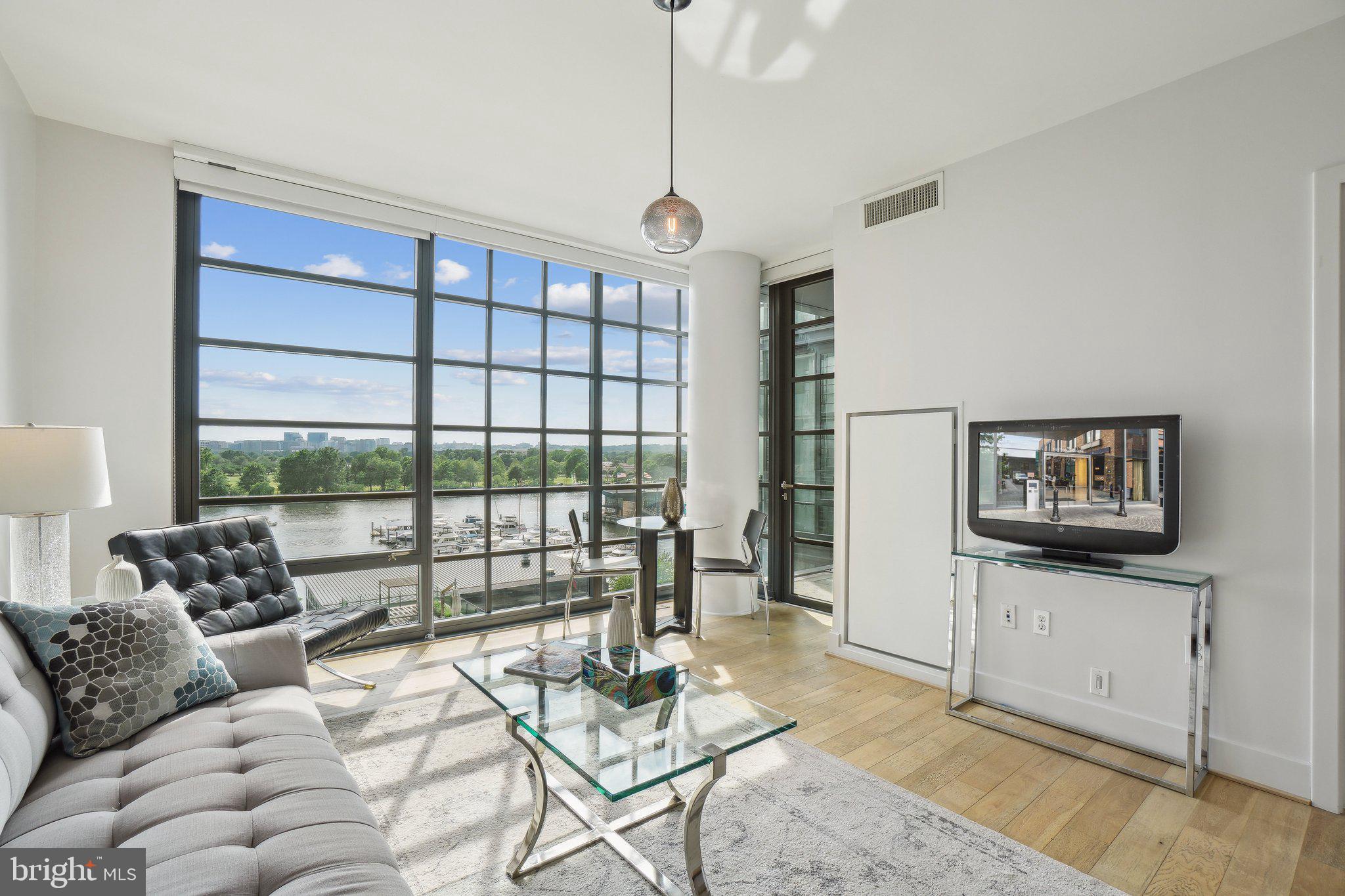 45 Sutton Square Southwest, Unit 602 Washington, DC 20024 - Photo 1 of 35 a living room with furniture and a floor to ceiling window