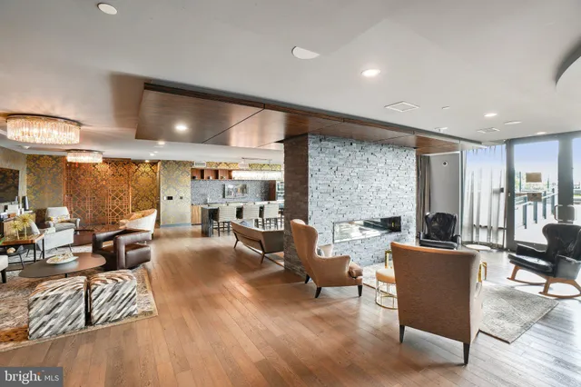 a living room with furniture and large windows