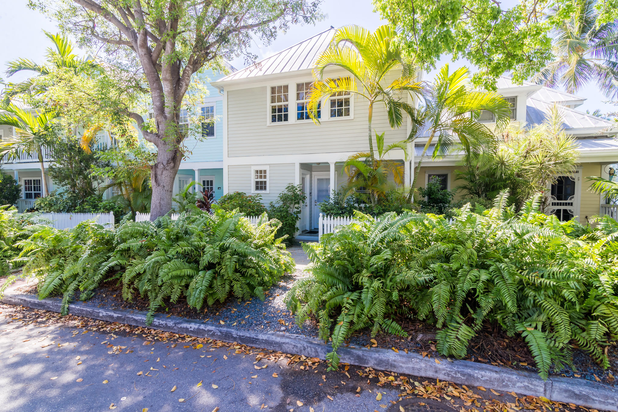 102 Southard Street, Unit 2 Key West, FL 33040 - Photo 19 of 25 a view of a white house with a large windows and plants