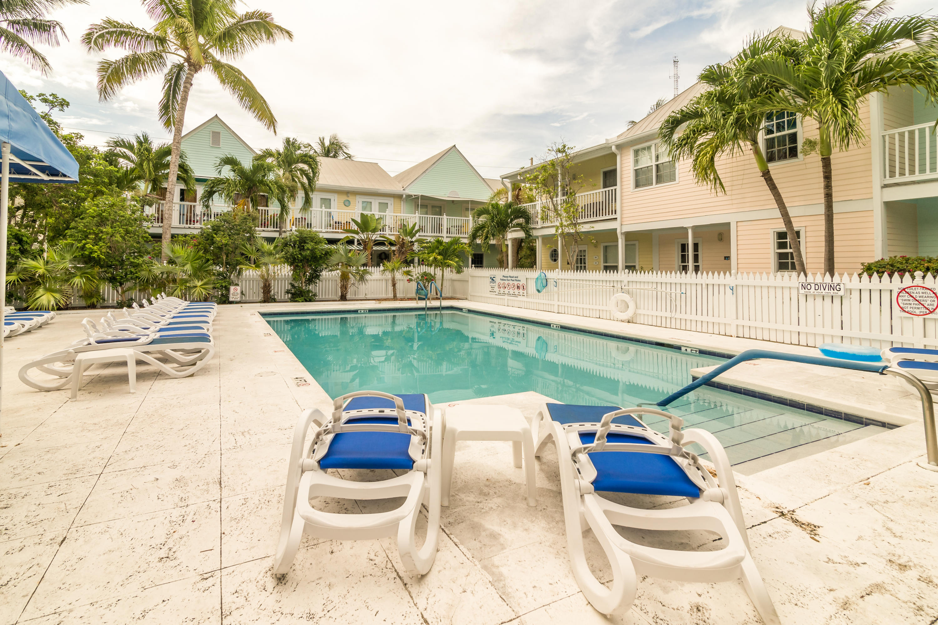 102 Southard Street, Unit 2 Key West, FL 33040 - Photo 22 of 25 a view of a white house with a swimming pool and sitting area