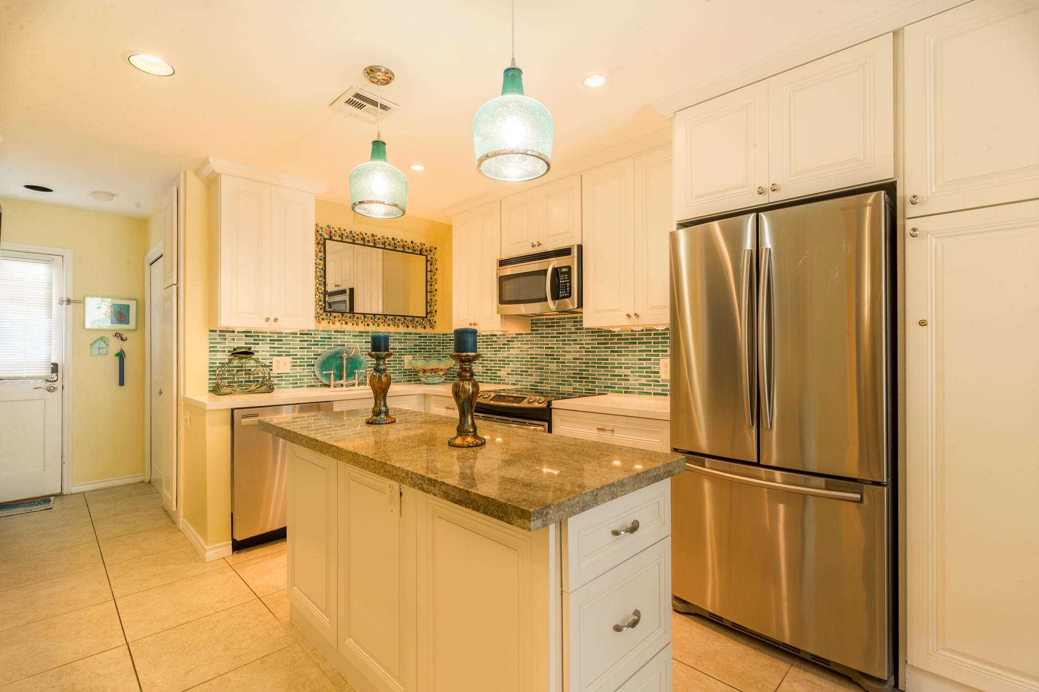 102 Southard Street, Unit 2 Key West, FL 33040 - Photo 6 of 25 a kitchen with stainless steel appliances granite countertop a refrigerator a oven and white cabinets with granite countertops