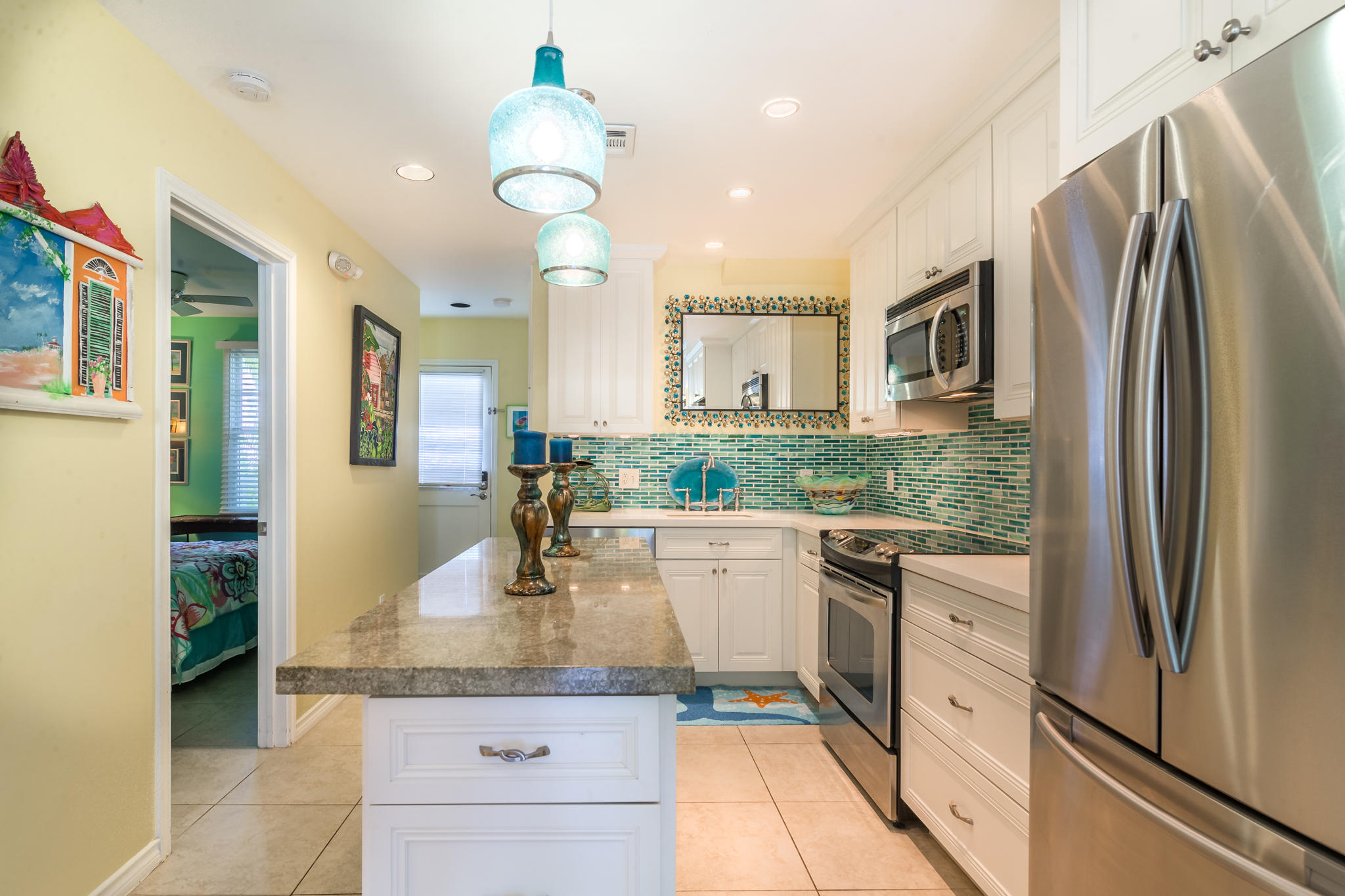 102 Southard Street, Unit 2 Key West, FL 33040 - Photo 7 of 25 a kitchen with kitchen island a counter top space cabinets and stainless steel appliances