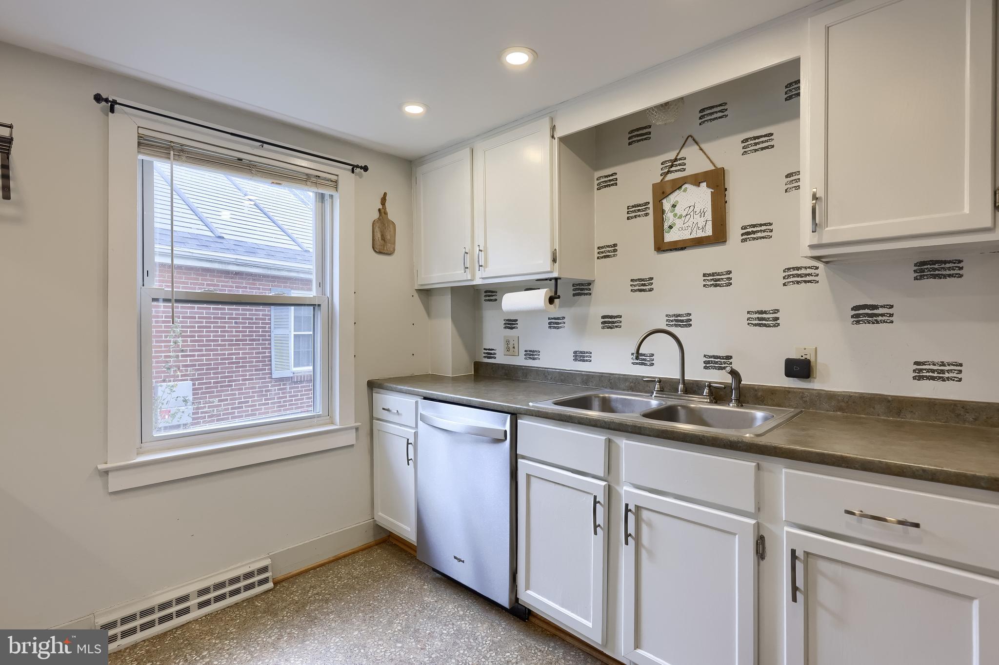 920 Chestnut Street Akron, PA 17501 - Photo 19 of 41 a kitchen with stainless steel appliances granite countertop white cabinets sink and window