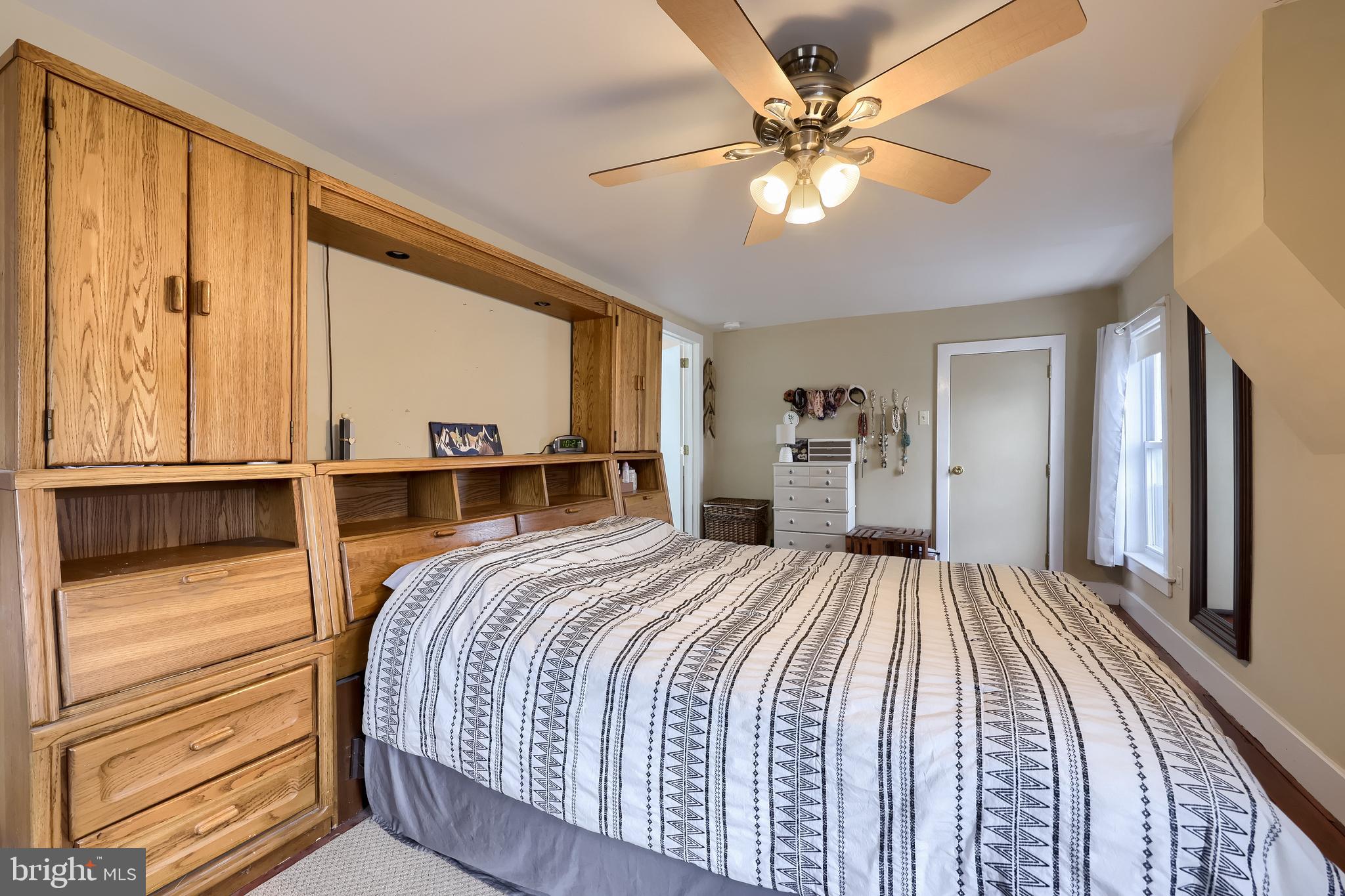 920 Chestnut Street Akron, PA 17501 - Photo 28 of 41 a bedroom with a large bed and a chandelier