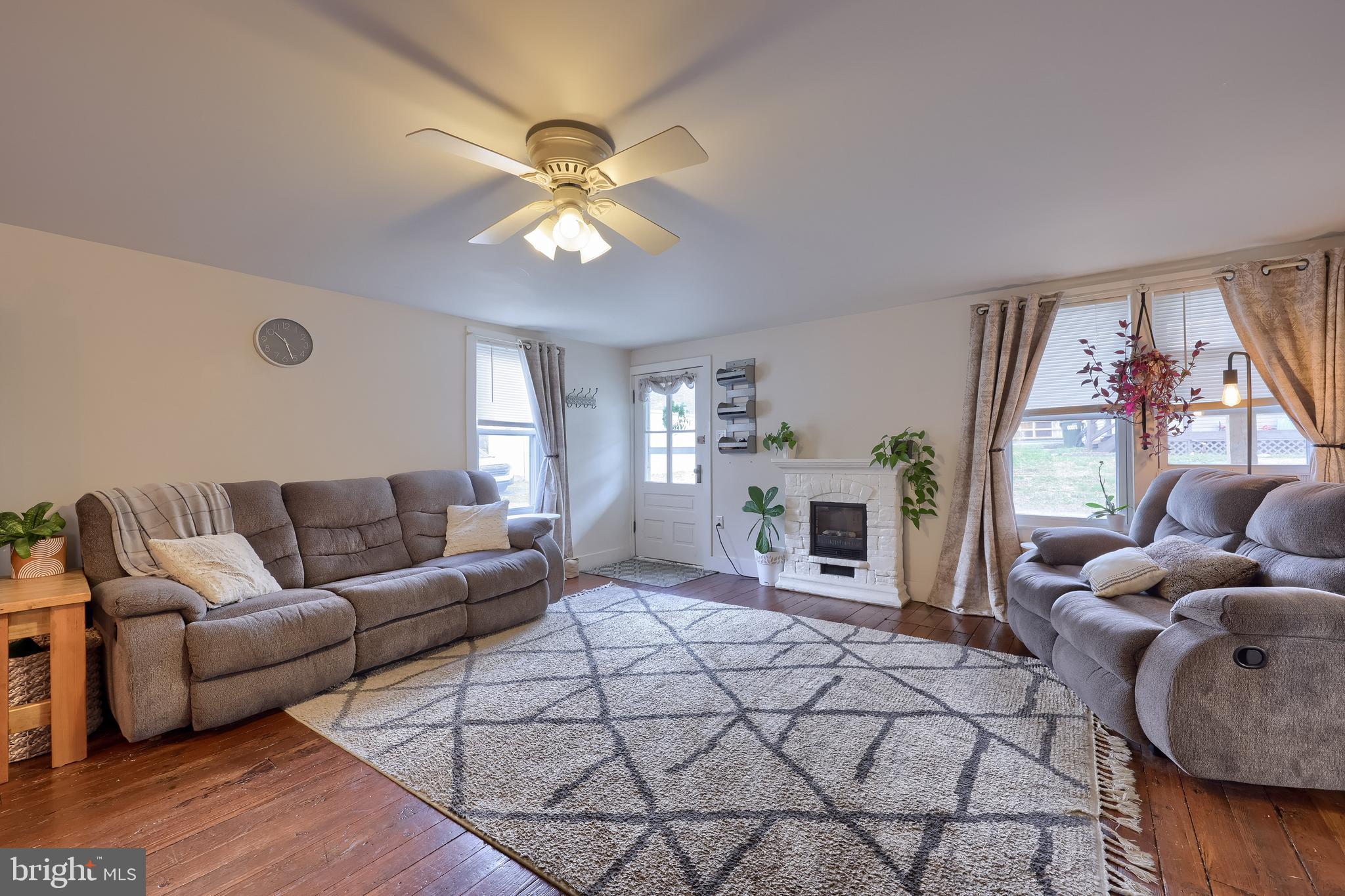 920 Chestnut Street Akron, PA 17501 - Photo 10 of 41 a living room with furniture a fireplace and a large window