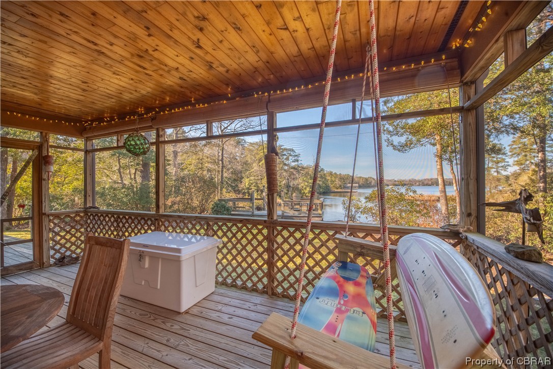 1239 Kelley Neck Road Lancaster, VA 22503 - Photo 13 of 48 Unfurnished sunroom featuring a water view, wooden ceiling, and a healthy amount of sunlight