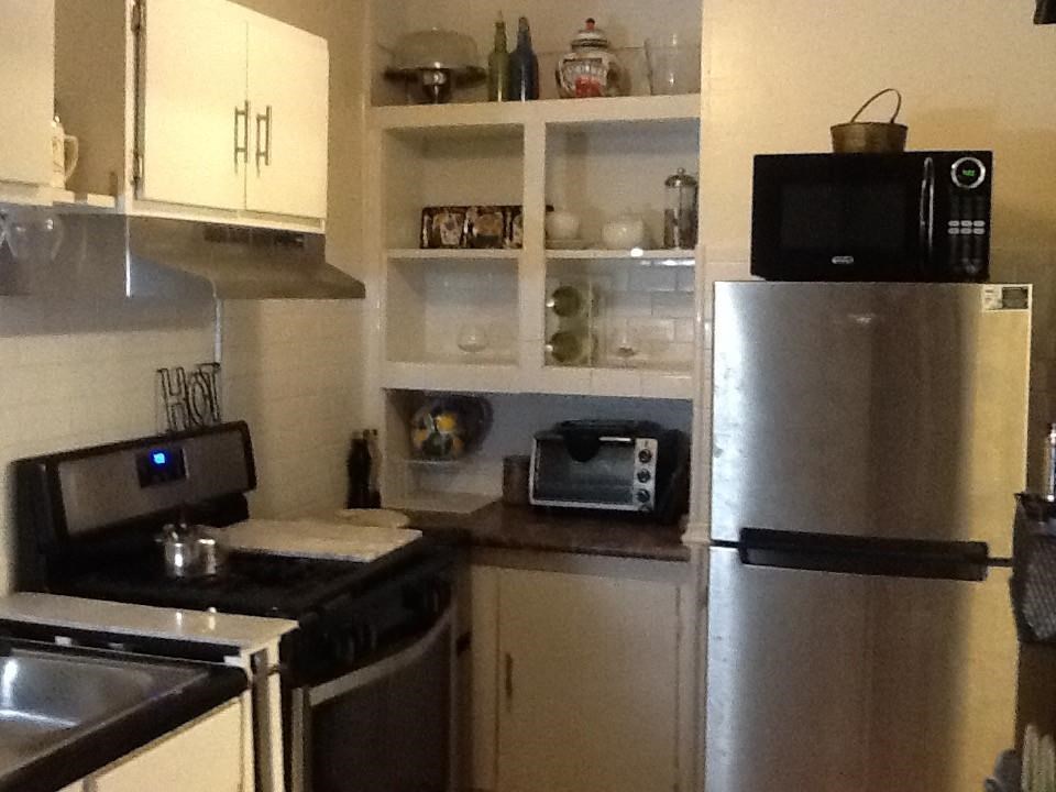 145 North Rembert Street Memphis, TN 38104 - Photo 11 of 25 a kitchen with a refrigerator and a stove