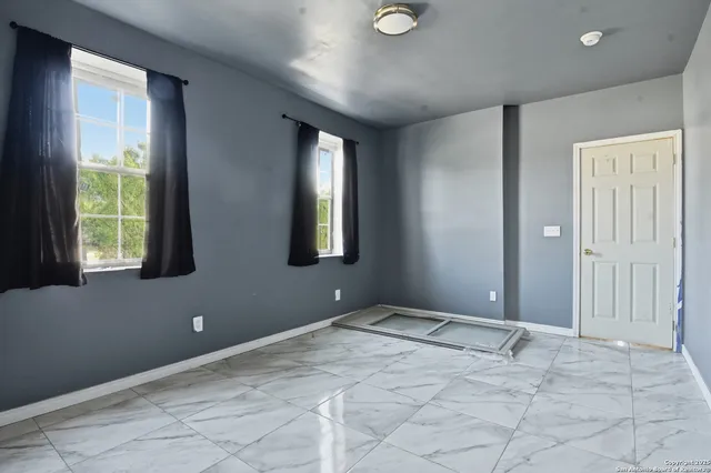 a view of an empty room with a window