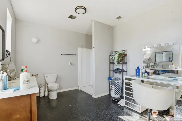 a room with a couch and a dining table