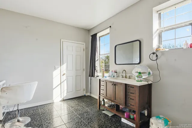 a bathroom with a sink a toilet and mirror