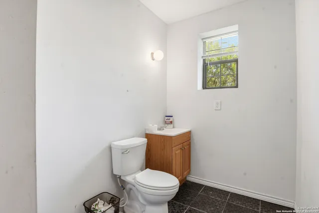 a white toilet sitting next to a small bathroom