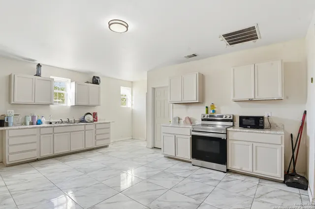 a kitchen with cabinets and appliances