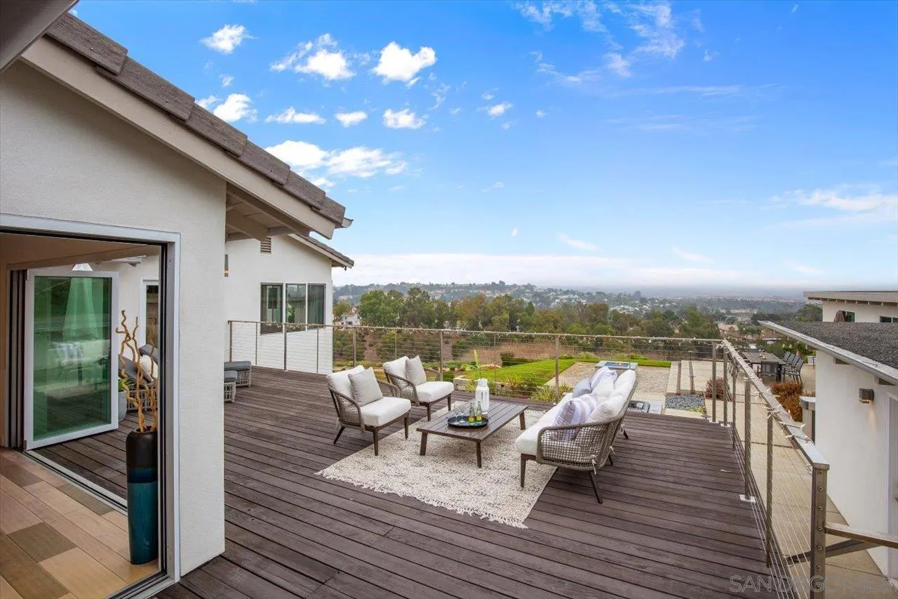 3800 Alder Avenue Carlsbad, CA 92008 - Photo 13 of 54 a view of a roof deck with dining table and chairs with wooden floor