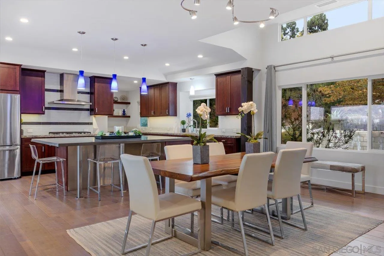 3800 Alder Avenue Carlsbad, CA 92008 - Photo 19 of 54 a dining area with stainless steel appliances kitchen island granite countertop a dining table and chairs