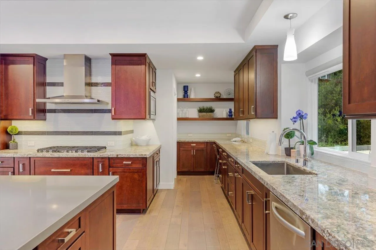 3800 Alder Avenue Carlsbad, CA 92008 - Photo 21 of 54 a kitchen with stainless steel appliances granite countertop a sink stove and refrigerator