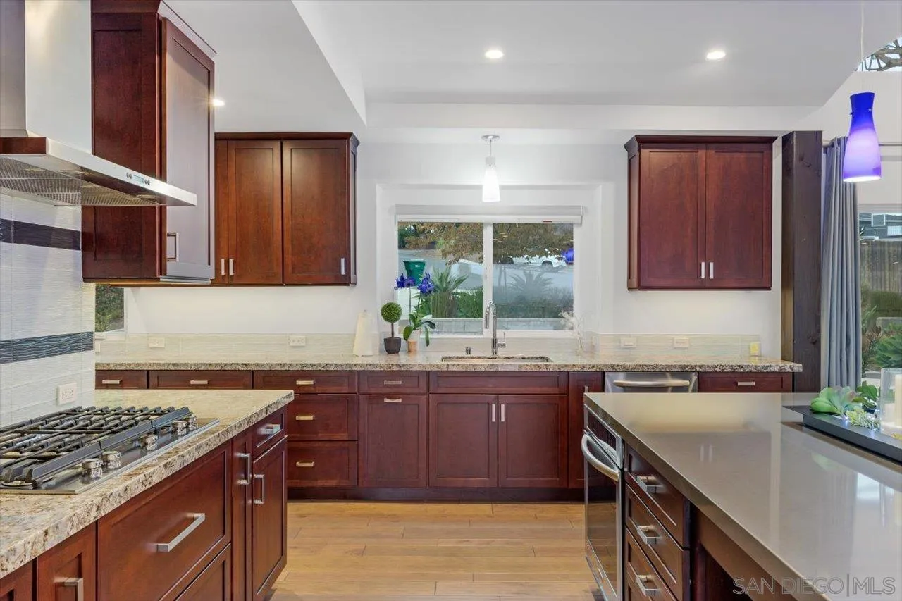 3800 Alder Avenue Carlsbad, CA 92008 - Photo 23 of 54 a kitchen with a sink stove and cabinets