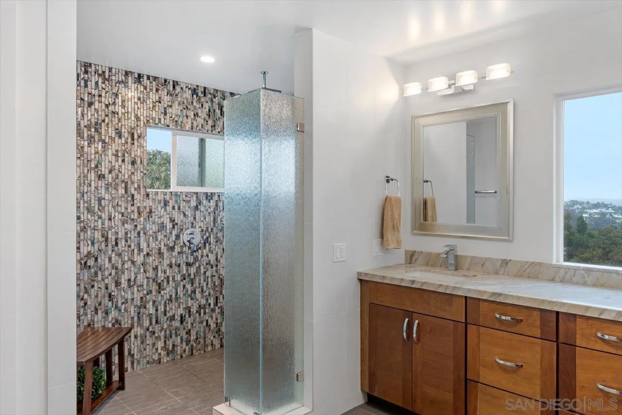 3800 Alder Avenue Carlsbad, CA 92008 - Photo 28 of 54 a bathroom with a granite countertop sink mirror and shower