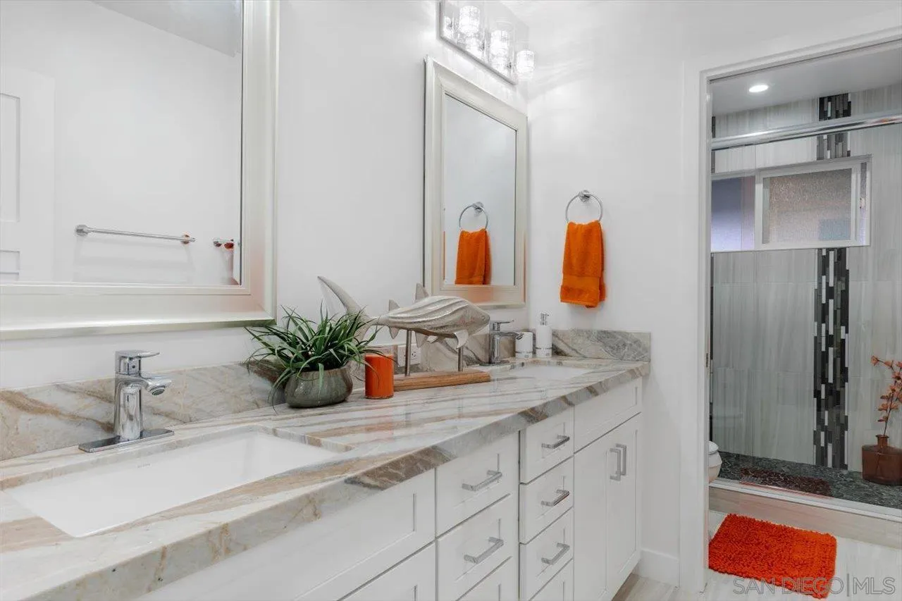 3800 Alder Avenue Carlsbad, CA 92008 - Photo 31 of 54 a bathroom with a double vanity sink and a mirror