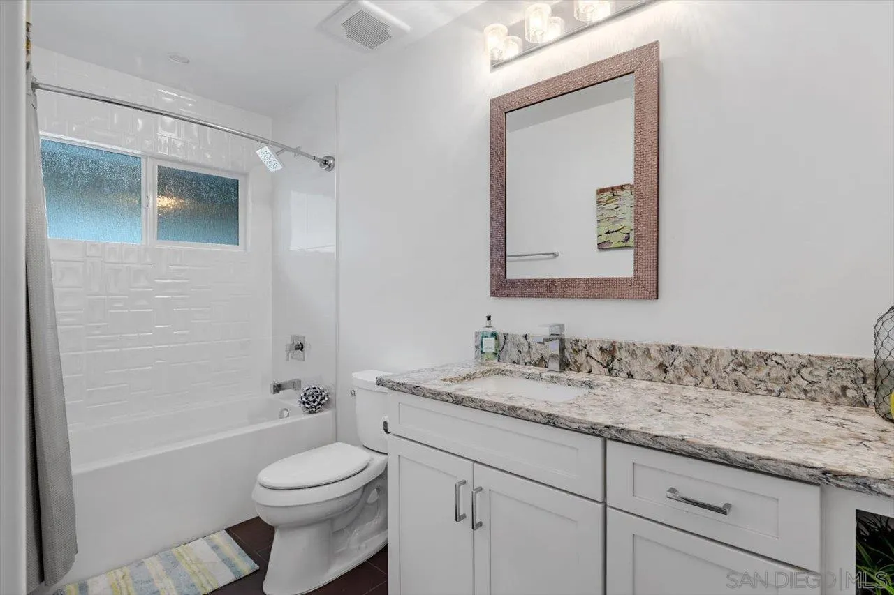 3800 Alder Avenue Carlsbad, CA 92008 - Photo 34 of 54 a bathroom with a granite countertop toilet sink and mirror