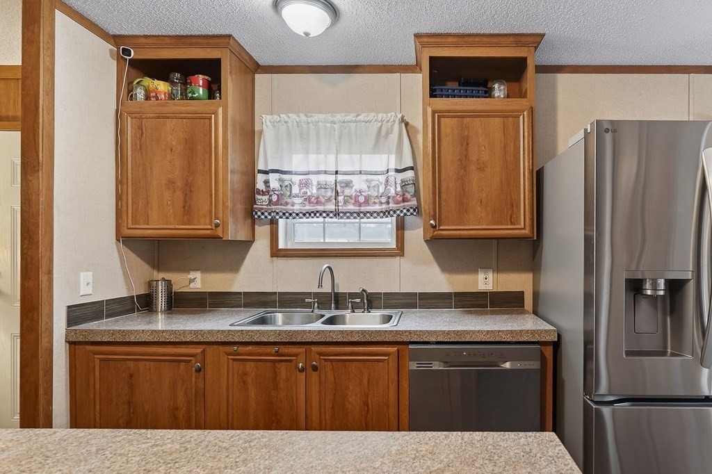 582 Doug Luna Road Walling, TN 38587 - Photo 12 of 47 a kitchen with stainless steel appliances granite countertop a refrigerator and a sink