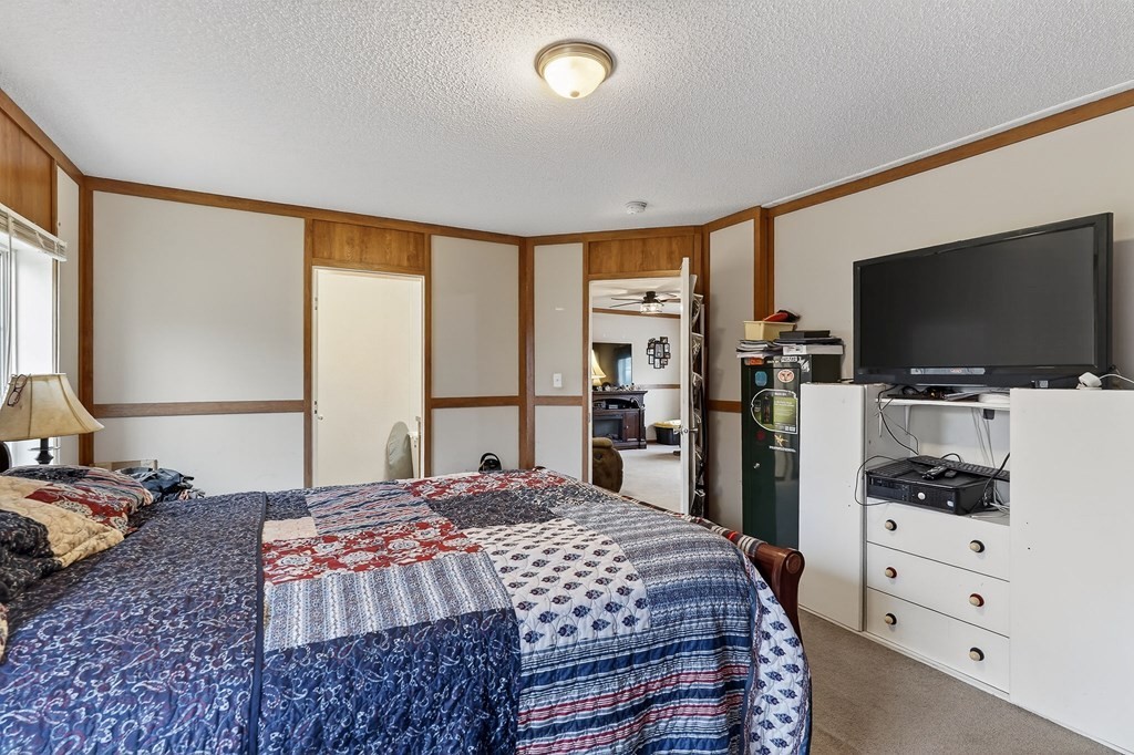 582 Doug Luna Road Walling, TN 38587 - Photo 18 of 47 a bedroom with a bed and a flat screen tv