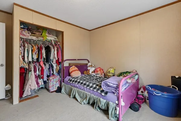 a bedroom with a bed and a view of walk in closet