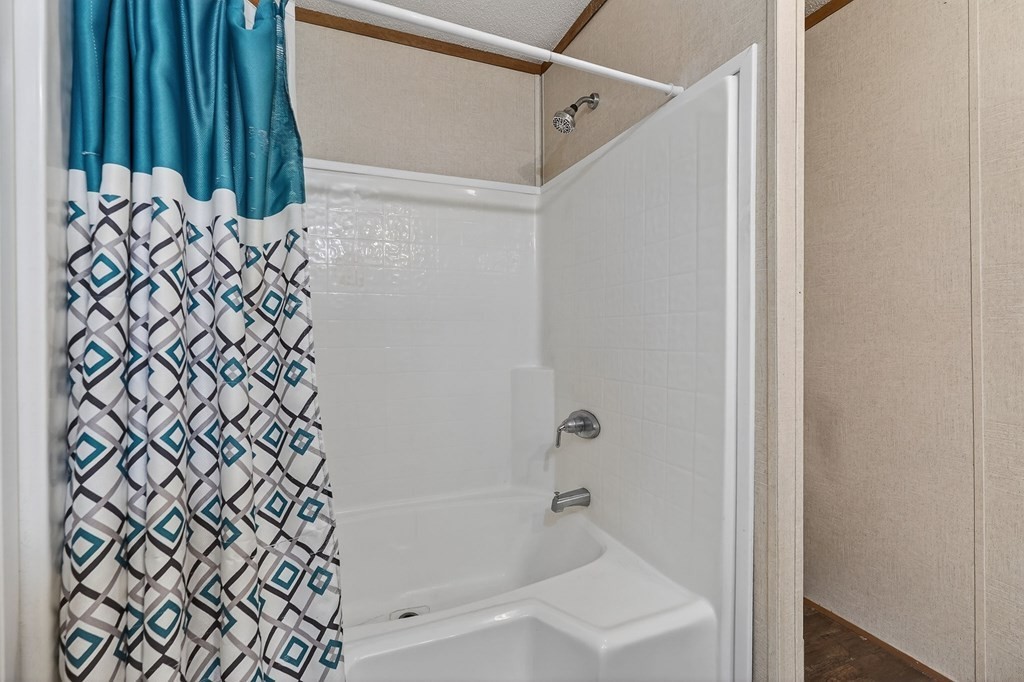 582 Doug Luna Road Walling, TN 38587 - Photo 23 of 47 a bathroom with a bathtub and shower
