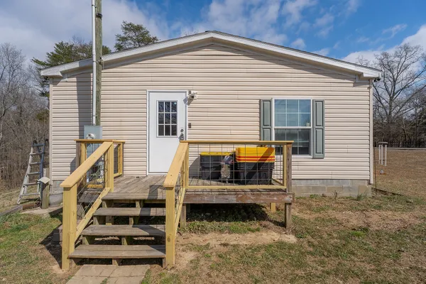 a view of a two chairs in the back yard of the house