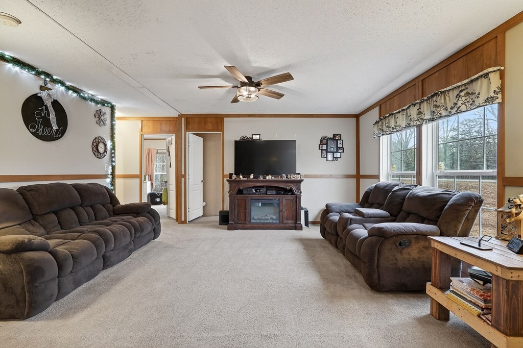 582 Doug Luna Road Walling, TN 38587 - Photo 7 of 47 a living room with furniture a large window and a flat screen tv