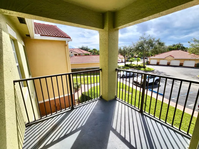 a view of a balcony with wooden floor