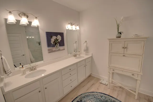 a bathroom with a double vanity sink and mirror