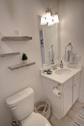 a bathroom with a sink toilet and a mirror