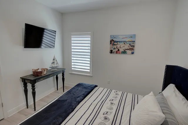 a bedroom with a bed and a flat screen tv