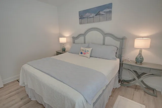 a bedroom with a bed and a lamp