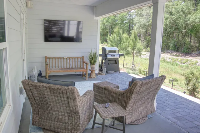 a living room with furniture and a floor to ceiling window