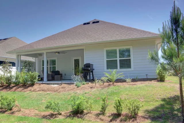 a front view of house with yard and outdoor seating