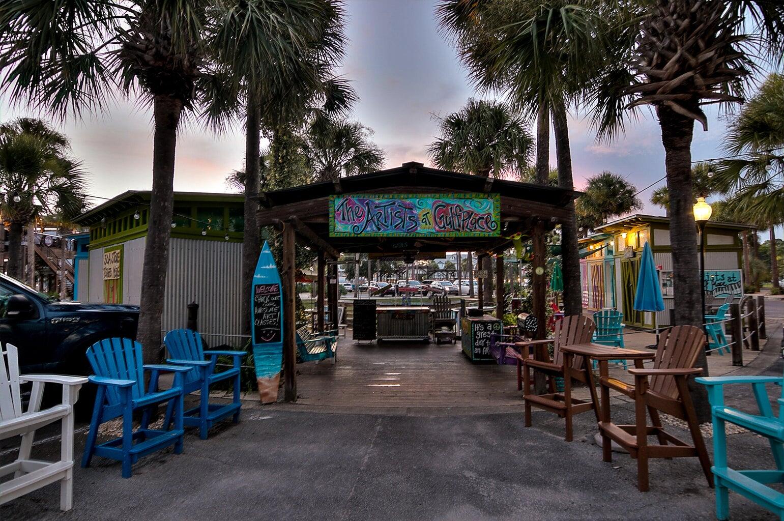 148 Piper Cove Santa Rosa Beach, FL 32459 - Photo 34 of 35 a view of a cafe with a table and chairs under an umbrella