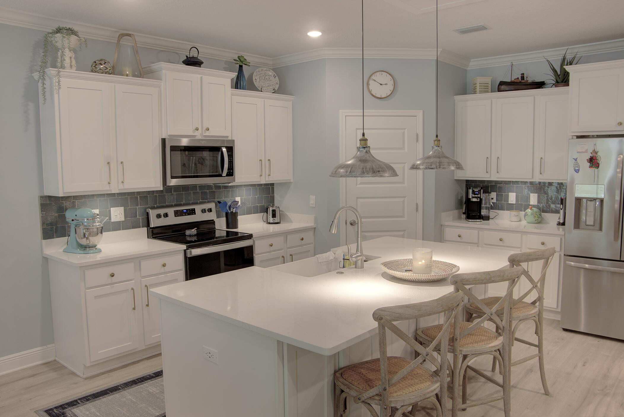148 Piper Cove Santa Rosa Beach, FL 32459 - Photo 6 of 35 a kitchen with stainless steel appliances kitchen island granite countertop a sink a stove a refrigerator and cabinets