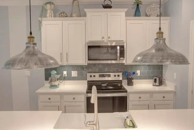 a kitchen with stainless steel appliances a stove a sink and a refrigerator