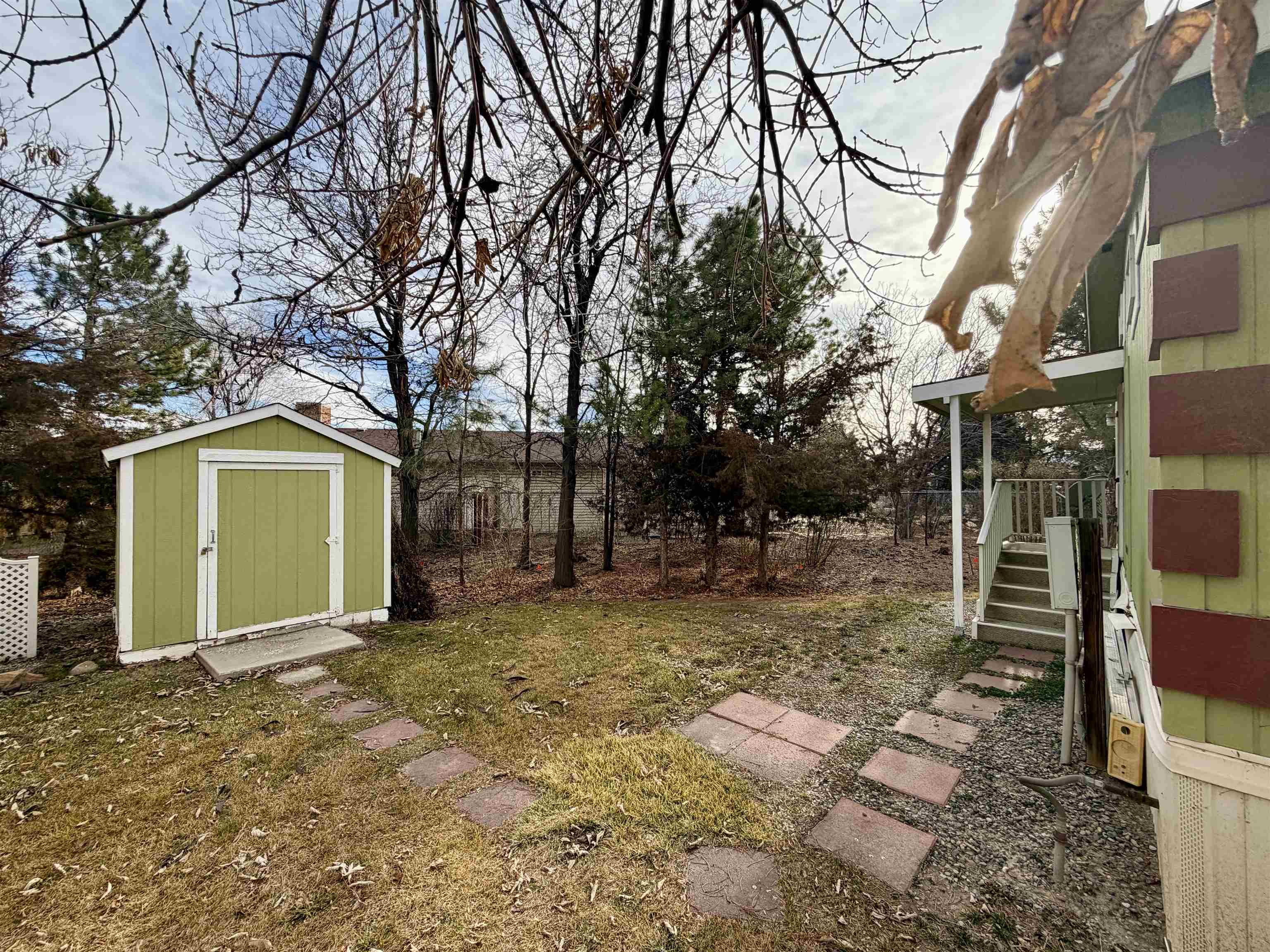435 32 Road, Unit 480 Clifton, CO 81520 - Photo 22 of 23 a view of a house with a yard and garage