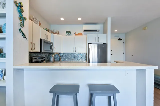 a kitchen with kitchen island a sink appliances and cabinets