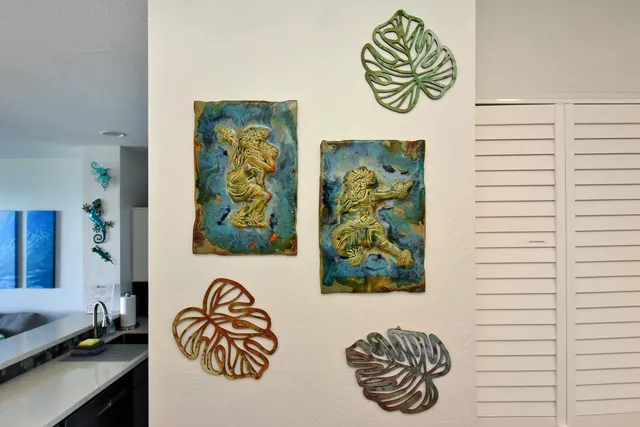 a bathroom with a window and a painting on the wall