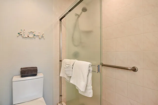 a bathroom with a shower and a mirror