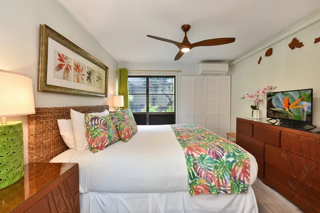 a bedroom with a bed and a flat screen tv